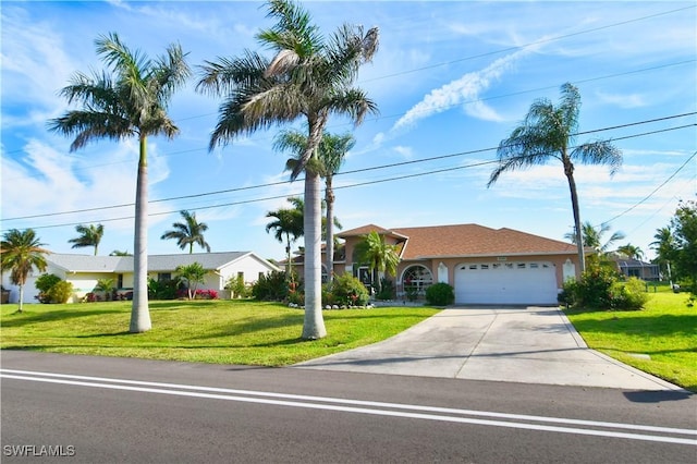 ranch-style home featuring a front yard, driveway, and an attached garage