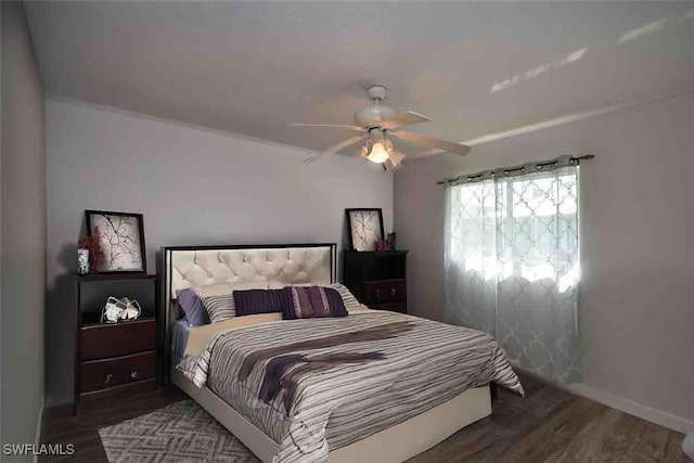 bedroom featuring ceiling fan, wood finished floors, and baseboards