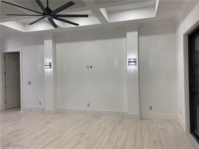 empty room featuring coffered ceiling, light wood-style flooring, and baseboards