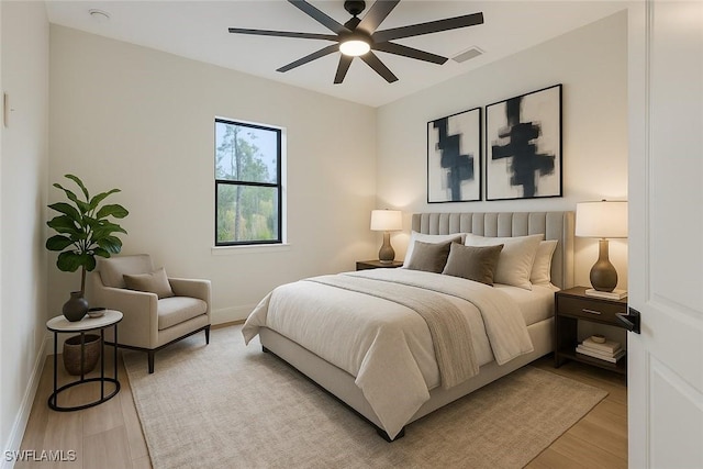 1929 14th Ave NE, Naples, FL 34120 - bedroom featuring a ceiling fan, baseboards, visible vents, and light wood-type flooring