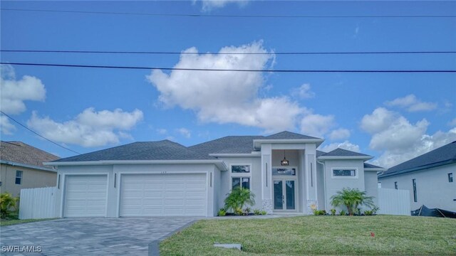 149 SE 21st St, Cape Coral, FL 33990 - view of front of property featuring a front yard, a garage, decorative driveway, fence, and stucco siding