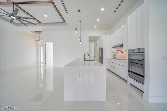 149 SE 21st St, Cape Coral, FL 33990 - kitchen featuring oven, modern cabinets, white cabinetry, under cabinet range hood, and a sink