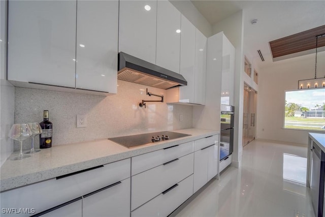 149 SE 21st St, Cape Coral, FL 33990 - kitchen with wall chimney range hood, modern cabinets, black electric stovetop, and white cabinetry