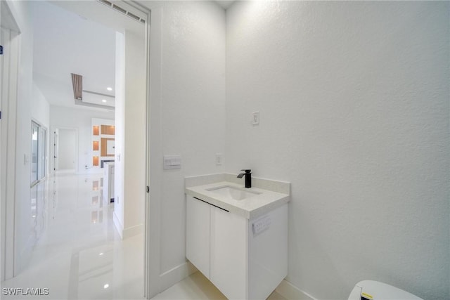 149 SE 21st St, Cape Coral, FL 33990 - bathroom featuring baseboards, a textured wall, toilet, and vanity
