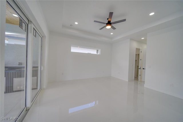 149 SE 21st St, Cape Coral, FL 33990 - spare room featuring a raised ceiling, a ceiling fan, and recessed lighting