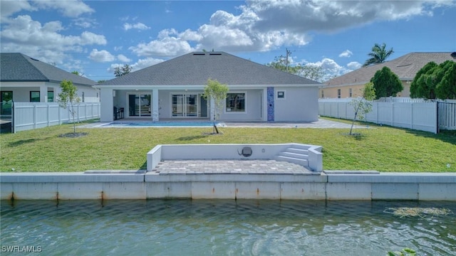 149 SE 21st St, Cape Coral, FL 33990 - rear view of property with a lawn, fence, and a water view