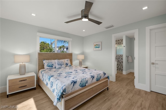 bedroom featuring light wood finished floors, a ceiling fan, visible vents, and baseboards