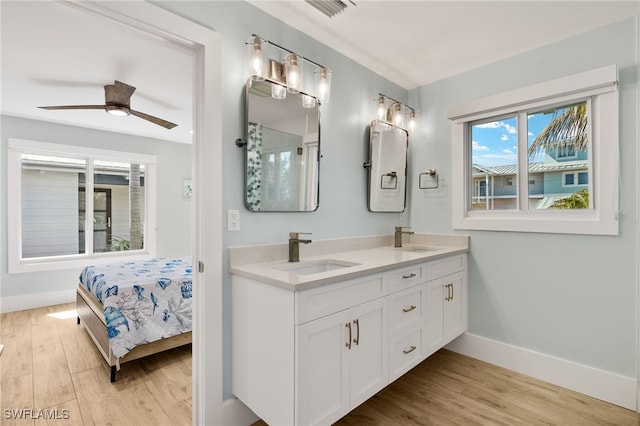 full bath featuring visible vents, a sink, and wood finished floors