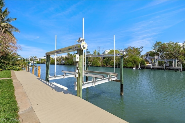 dock area with a water view and boat lift