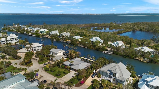 drone / aerial view featuring a water view and a residential view