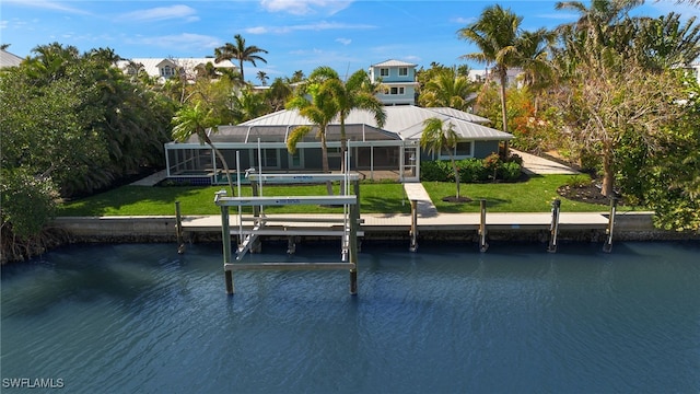 view of dock featuring glass enclosure, a water view, and a lawn