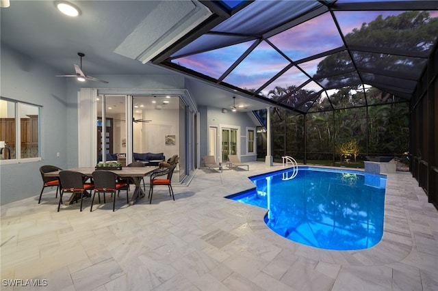 outdoor pool with a lanai, ceiling fan, and a patio