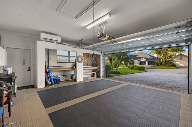 garage with a garage door opener, a wall mounted air conditioner, and a workshop area