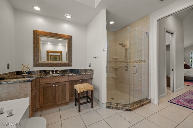 full bath featuring a stall shower, tile patterned flooring, and ensuite bathroom