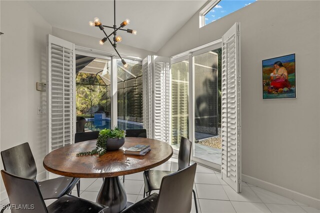 dining space featuring tile patterned flooring, a chandelier, vaulted ceiling, and baseboards