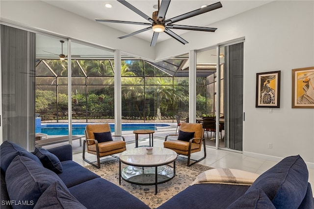 tiled living room with a sunroom, baseboards, a ceiling fan, and recessed lighting