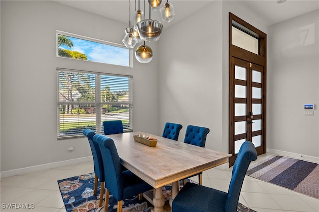 dining space with light tile patterned floors and baseboards