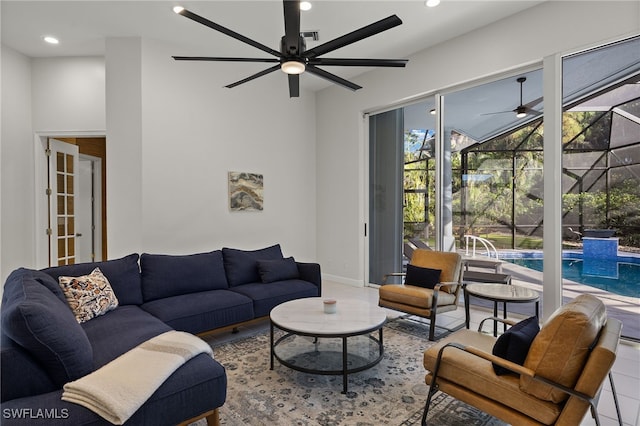 living room featuring a sunroom, baseboards, a ceiling fan, and recessed lighting