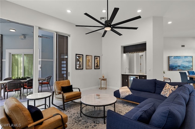 living room featuring recessed lighting, visible vents, ceiling fan, bar, and baseboards