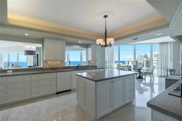 kitchen with dark countertops, paneled dishwasher, plenty of natural light, and a sink