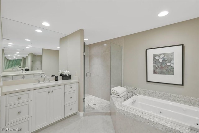 bathroom featuring vanity, a jetted tub, recessed lighting, and a stall shower