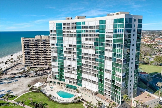 view of building exterior with a city view and a water view