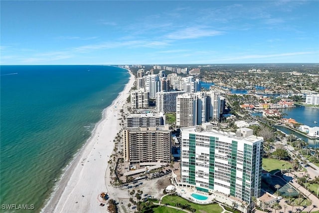 drone / aerial view with a beach view, a view of city, and a water view