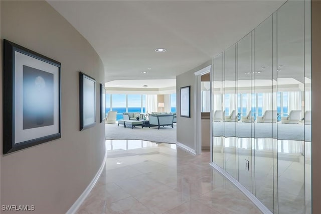 hallway featuring recessed lighting and baseboards