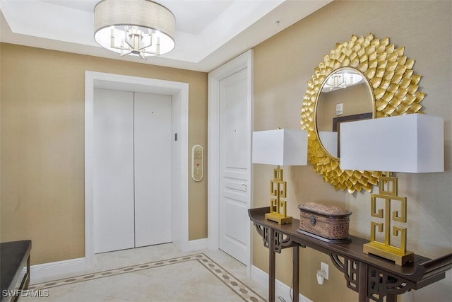 970 Cape Marco Dr Unit 1107, Marco Island, FL 34145 - entrance foyer featuring elevator, tile patterned flooring, baseboards, and a chandelier