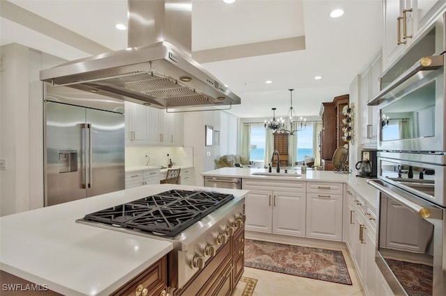 970 Cape Marco Dr Unit 1107, Marco Island, FL 34145 - kitchen featuring a center island, appliances with stainless steel finishes, a sink, island range hood, and a peninsula