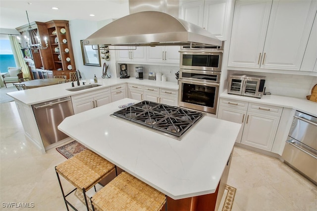 970 Cape Marco Dr Unit 1107, Marco Island, FL 34145 - kitchen featuring stainless steel appliances, a peninsula, a sink, white cabinets, and island exhaust hood