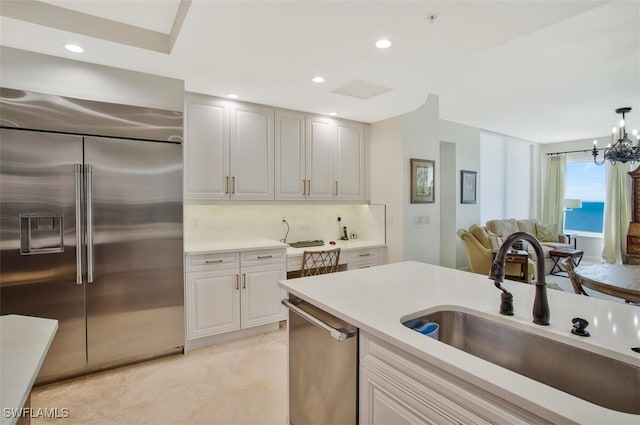 970 Cape Marco Dr Unit 1107, Marco Island, FL 34145 - kitchen with stainless steel appliances, recessed lighting, light countertops, decorative backsplash, and a sink