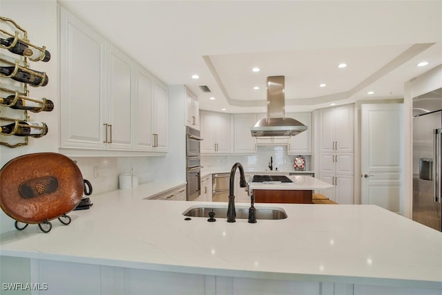 970 Cape Marco Dr Unit 1107, Marco Island, FL 34145 - kitchen featuring visible vents, island range hood, a sink, a tray ceiling, and backsplash