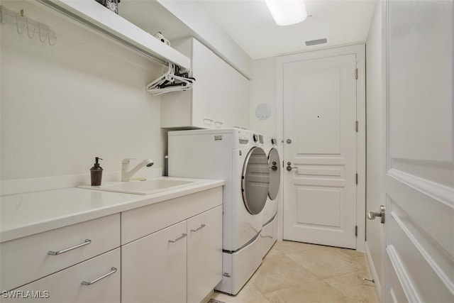 970 Cape Marco Dr Unit 1107, Marco Island, FL 34145 - laundry area with washer and clothes dryer, visible vents, cabinet space, light tile patterned flooring, and a sink