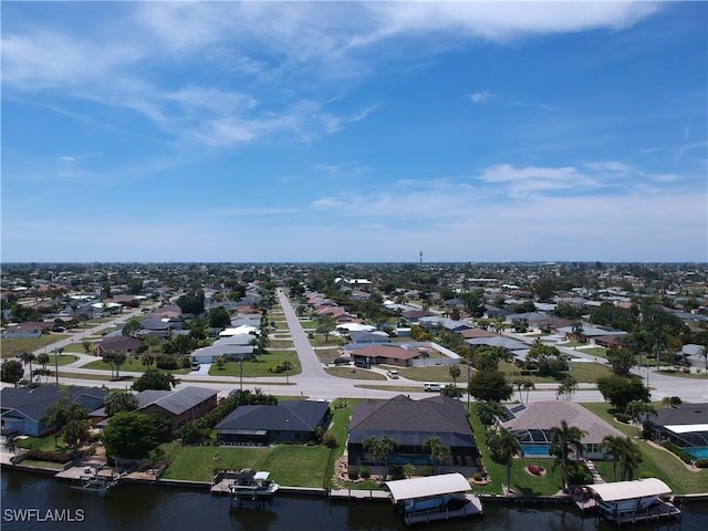 birds eye view of property featuring a water view and a residential view