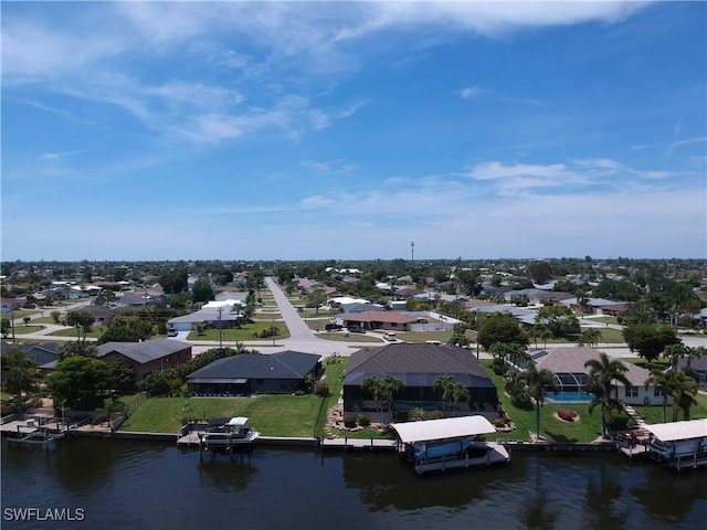 birds eye view of property featuring a water view and a residential view