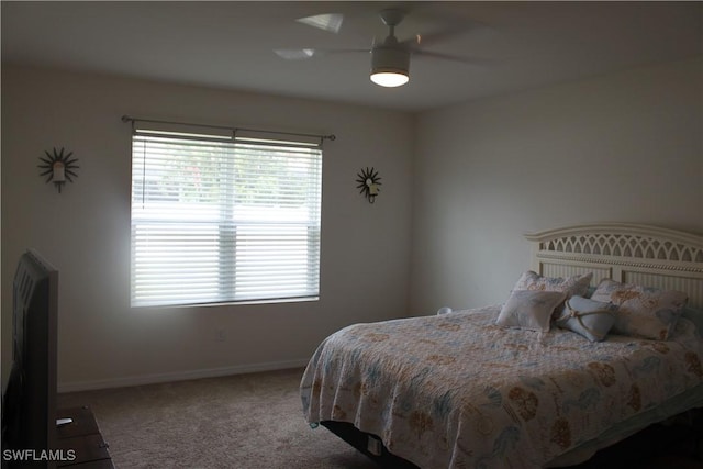 carpeted bedroom featuring a ceiling fan and baseboards