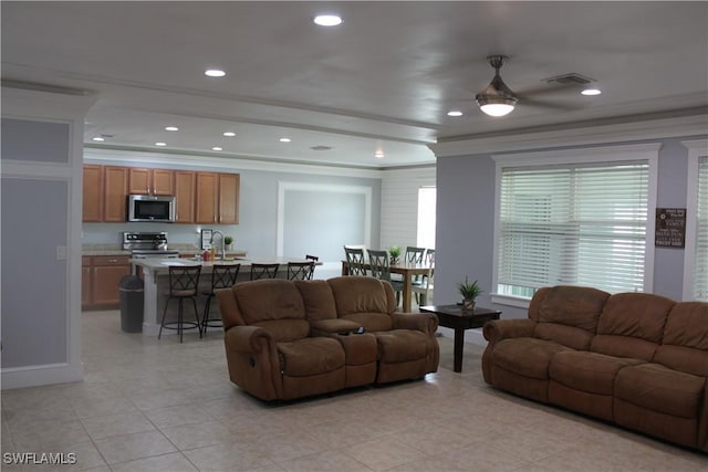 living room featuring ornamental molding, light tile patterned flooring, visible vents, and recessed lighting