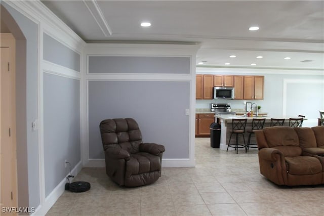 interior space featuring light tile patterned floors, baseboards, arched walkways, and recessed lighting