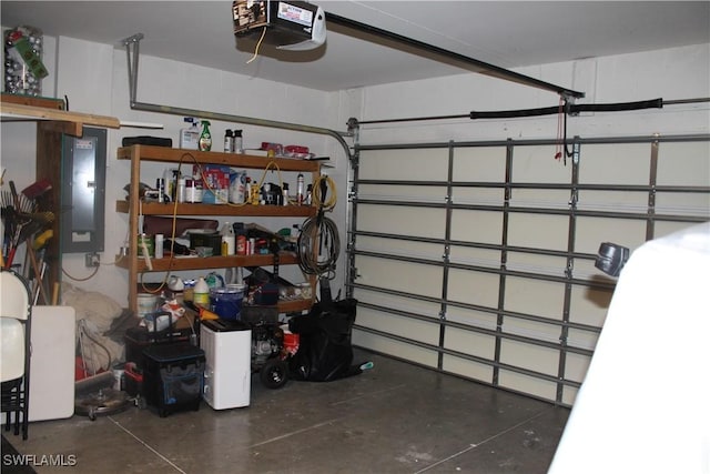 garage with electric panel and a garage door opener