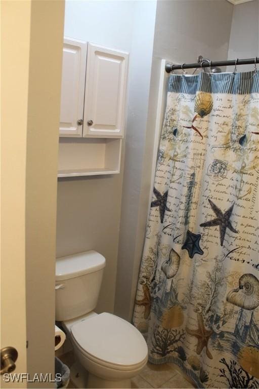 bathroom with toilet, a shower with shower curtain, and tile patterned floors