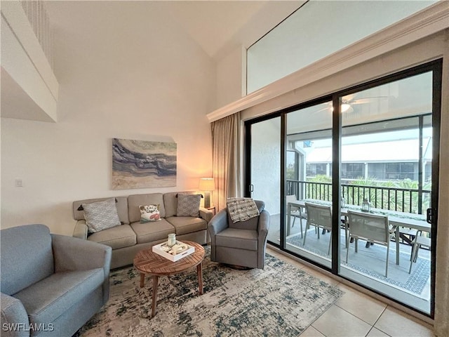 living room with a high ceiling and light tile patterned flooring