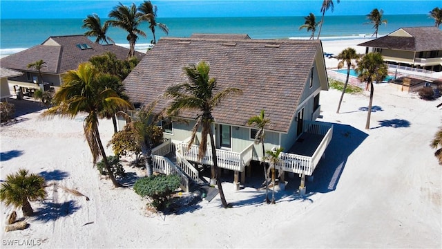 aerial view with a water view and a view of the beach