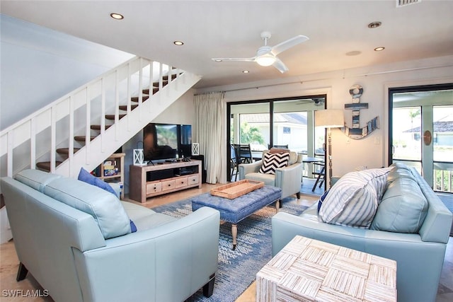 living area featuring recessed lighting, visible vents, ceiling fan, and stairway