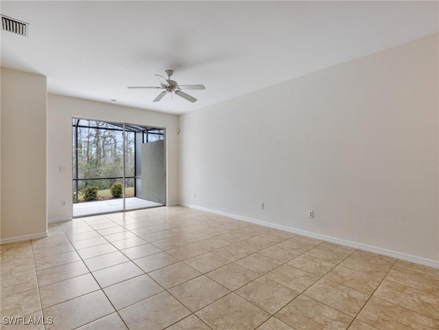 empty room with baseboards, visible vents, and a ceiling fan