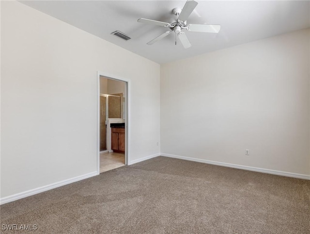 unfurnished room with baseboards, ceiling fan, visible vents, and carpet flooring