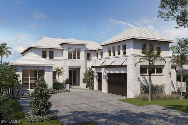 contemporary house with stucco siding, a garage, and driveway