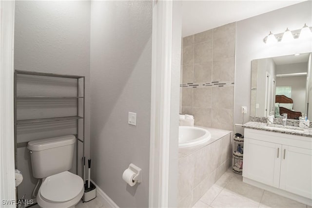 full bath with tiled bath, tile patterned flooring, vanity, and toilet