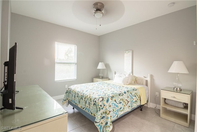 bedroom with light tile patterned floors, baseboards, and a ceiling fan