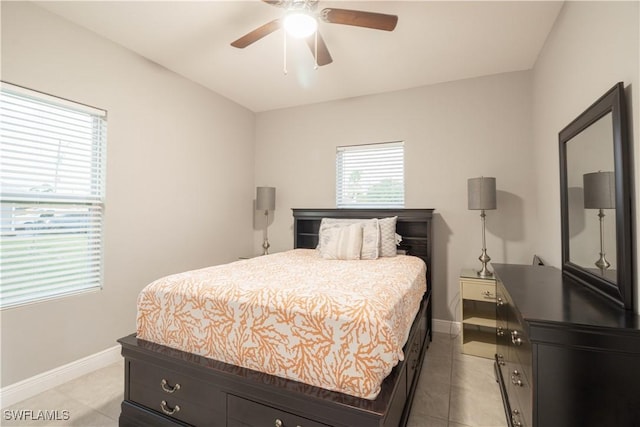 bedroom featuring light tile patterned floors, baseboards, and a ceiling fan